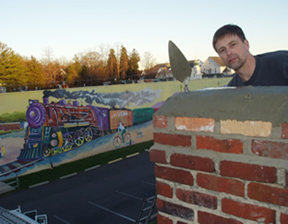 John Nicholas Petro on top of Vienna Train Station repairing chimney